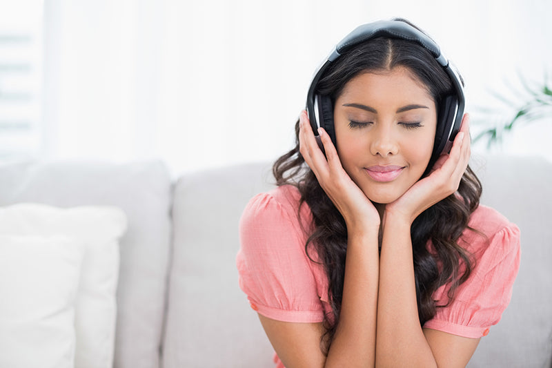 Woman listening to Bluetooth headphones 